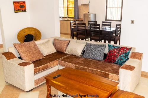 a living room with a couch and a table at Sisitop Hotel and Apartment Kisumu in Kisumu