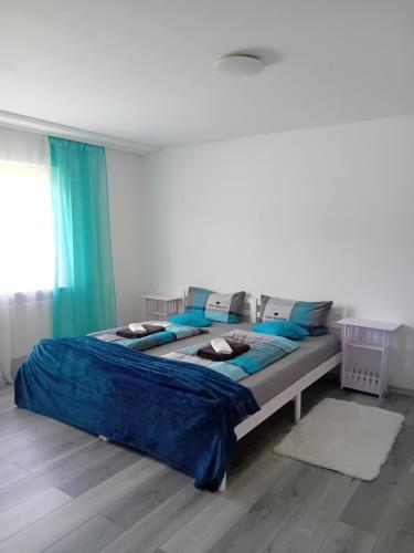 a large bed in a bedroom with blue pillows at Ferienwohnung in Arrach