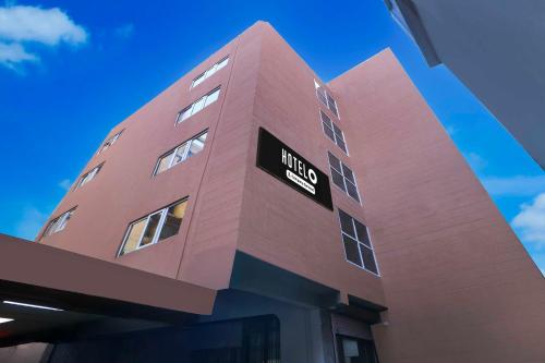 a pink building with a hotel sign on it at Hotel O Ranchi Station Near Rajendra Chowk in Rānchī