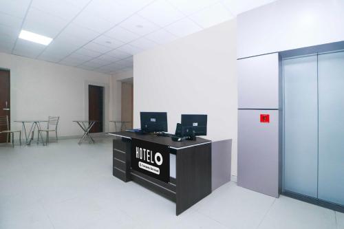 an office with a desk with two computers on it at Hotel O Ranchi Station Near Rajendra Chowk in Rānchī