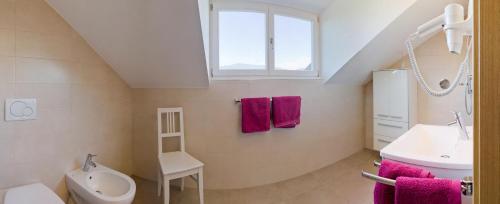 a bathroom with a sink and a toilet and a window at Ferienwohnungen St. Michael in Appiano sulla Strada del Vino