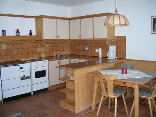 a kitchen with a table and a table and chairs at Riedhof in Mieders