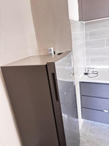 a bathroom with a sink and a counter top at Stay with queen in Marimbeti