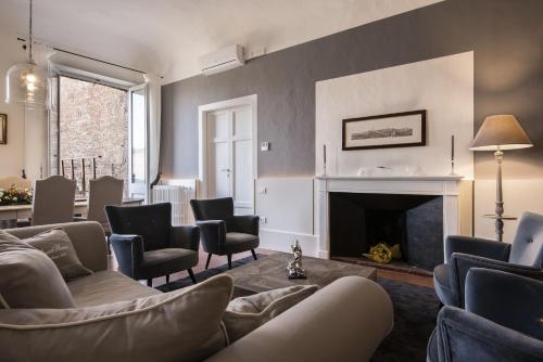 a living room with couches and chairs and a fireplace at La Terrazza Sul Campo-Rooms Only in Siena
