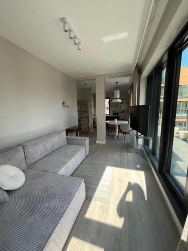 a living room with a couch and a table at Legnica4 in Legnica