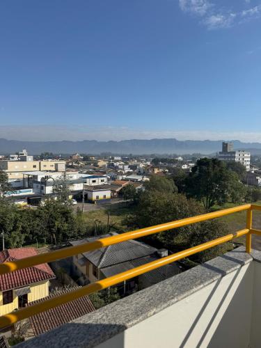 a view of a city from a balcony at Rio Jordao Hotel in Siderópolis