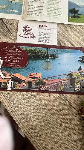 a sign on a table with a picture of a river at Casa Lidia in Ossuccio