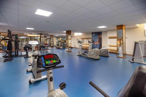 a gym with a blue gym floor with machines at Hotel Servigroup Marina Mar in Mojácar