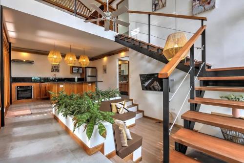 a living room with a staircase and a kitchen at Porto Alegre in Punta Uva