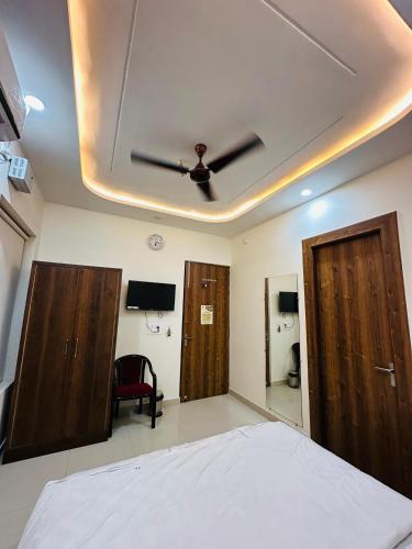 a bedroom with a bed and two wooden doors at Hotel Grand Central in Bulandshahr