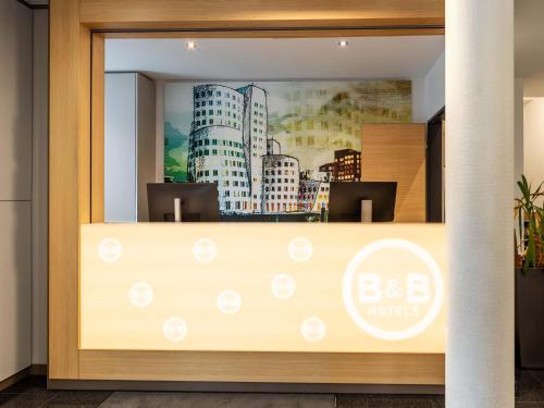 an office window with a picture of buildings at B&B Hotel Düsseldorf City-Süd in Düsseldorf