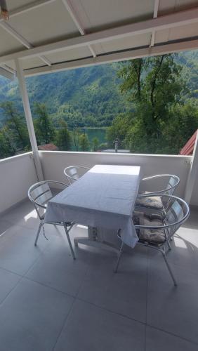 a table and chairs on a balcony with a view at Boračko jezero Apartment "doelend" in Konjic