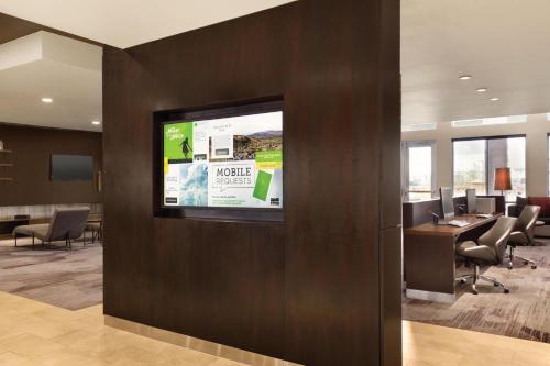 an office with a flat screen tv on a wall at Courtyard by Marriott El Paso East/I-10 in El Paso
