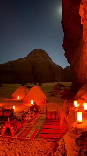 two orange tents in the desert at night at Wadi Rum Magic Camp in Wadi Rum