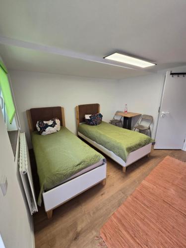 a room with two beds and a table in it at Appartement Kristina in Biblis