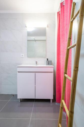 a bathroom with a sink and a mirror at Avó Benta 1 in Faial da Terra