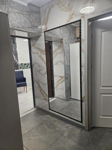 a mirror in front of a door in a room at Noclegi Gracja in Wałbrzych