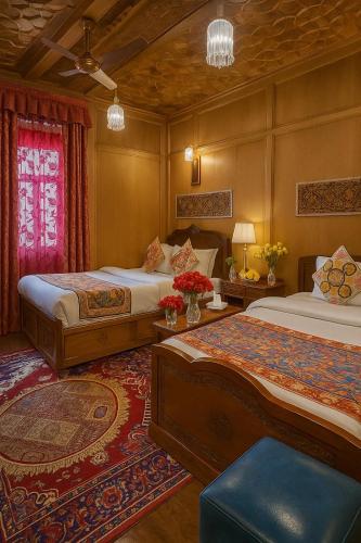 a hotel room with two beds in a room at Lake Victoria Houseboats in Srinagar