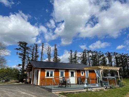 a house with a gazebo on the side of a road at Log Cabin with Hot Tub Large Patio Near Cork city in Cork