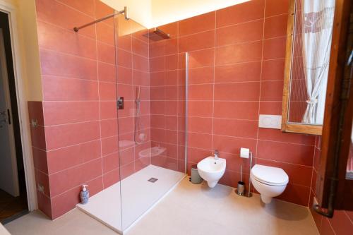 a bathroom with a toilet and a glass shower at Villa Morandi in Florence
