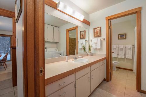 a bathroom with a sink and a mirror at RMR: Columbine 1011 Condo in The AspensWilsonWY in Wilson