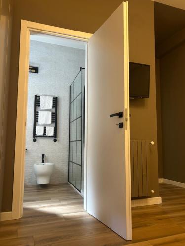 an open door to a bathroom with a toilet at A Due Passi Dalla Scalinata Rooms in Caltagirone
