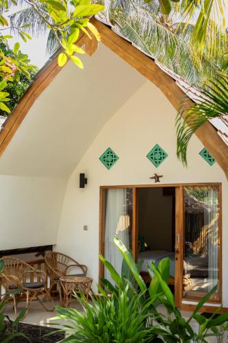a view of the outside of a house with a patio at The New Gili Kolanta Indah in Gili Air