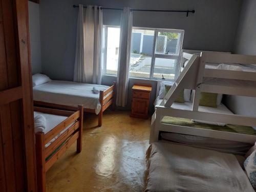 a room with three bunk beds and a window at Ballito Floridian in Ballito