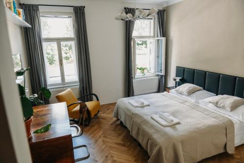 a bedroom with two beds and two windows at Bed&Breakfast & Apartment Klafé in Brno