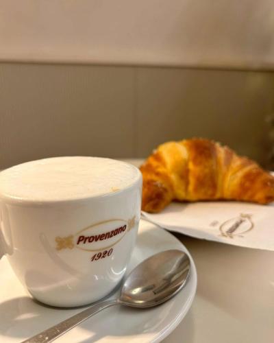 a cup of coffee and a pastry on a table at La Casetta in Tuglie