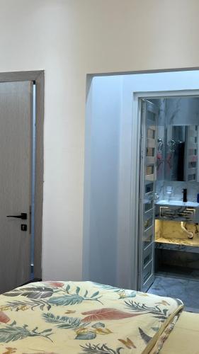a bedroom with a bed and a closet with a mirror at Sumeras Sapphire Retreat in Ajman 