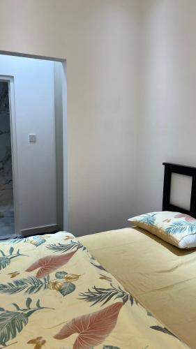 a bedroom with a bed with a pillow on it at Sumeras Sapphire Retreat in Ajman 