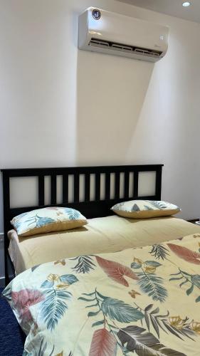 two beds sitting next to each other in a room at Sumeras Sapphire Retreat in Ajman 