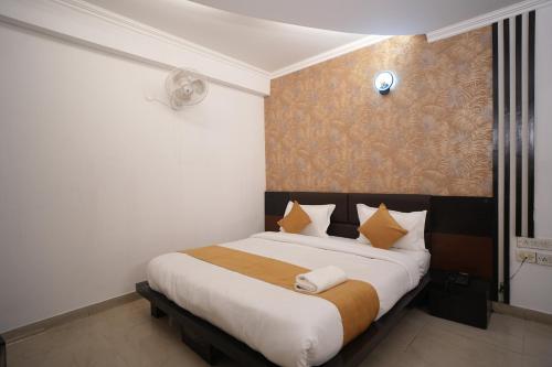 a bedroom with a large bed in a room at Golden Palm Residency in New Delhi