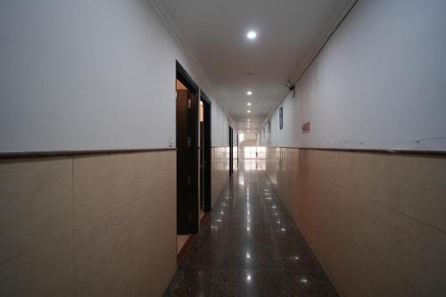an empty hallway of a building with a hallway at Golden Palm Residency in New Delhi
