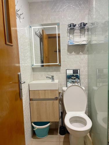 a bathroom with a toilet and a sink and a mirror at Basim Filali in Kenitra