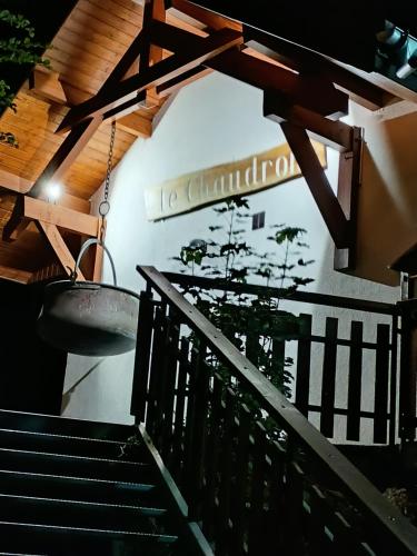 a stairway with a sign on the wall and a basket at Auberge le Chaudron in Montsapey
