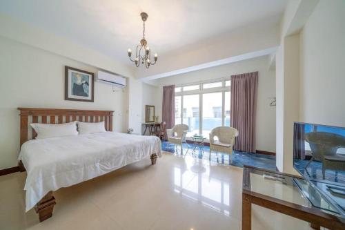 a bedroom with a bed and a tv in it at 花蓮發現民宿-無人民宿自助入住-包棟可烤肉可麻將 in Hualien City