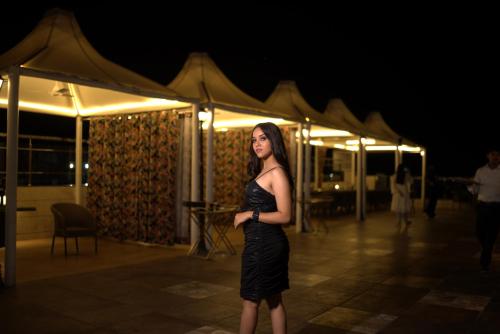a woman in a black dress standing in front of a tent at Hotel Pradeep Star Inn in Gorakhpur