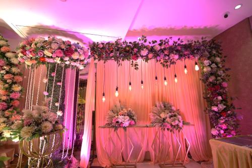 a room with pink and purple flowers and chairs at Hotel Pradeep Star Inn in Gorakhpur