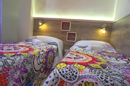 two beds sitting next to each other in a room at Mucho Madrid in Madrid