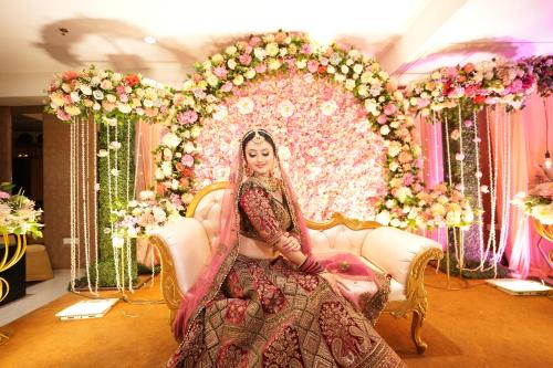 a bride sitting in a chair in front of a altar at Hotel Pradeep Star Inn in Gorakhpur