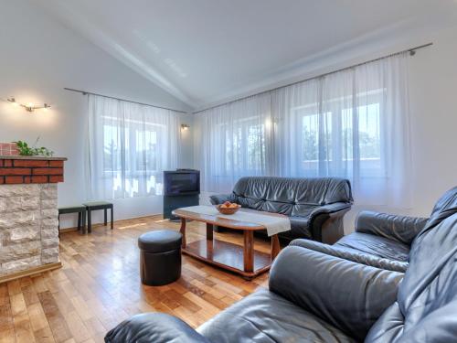 a living room with two couches and a table at Holiday Home VIlla Eldina by Interhome in Škatari