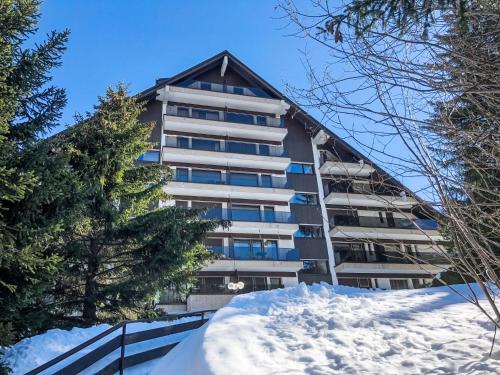 a building with snow in front of it at Apartment Victoria B 7 by Interhome in Crans-Montana