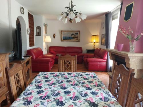 a living room with a bed and a red couch at Holiday Home Ste Claire by Interhome in Solliès-Pont