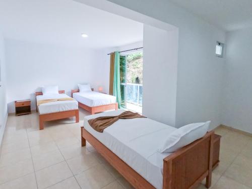 Residencial Mãe Nonaにあるベッド