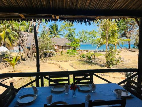 a blue table with a view of the beach at Djema Forest in Nosy Be