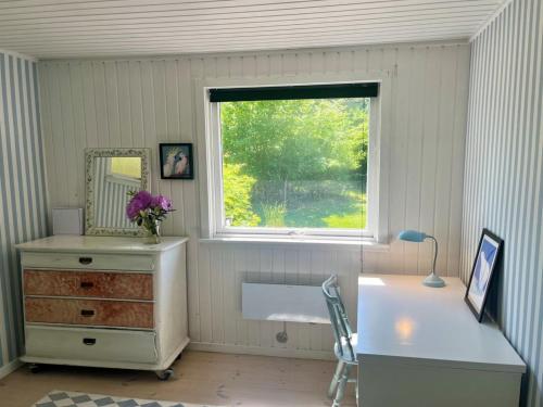 a room with a dresser and a window and a desk at Holiday Home Eragon - 1-2km from the sea by Interhome in Gilleleje