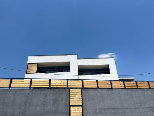 a building on top of a wall with a blue sky at Luxury Villa Agaraki with Pool in Tbilisi City