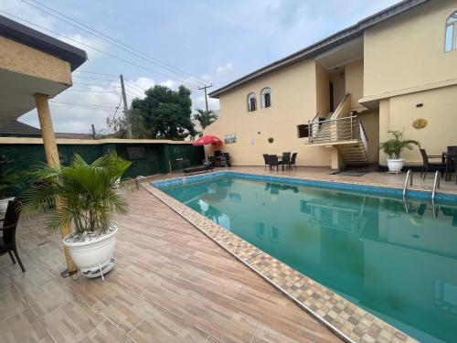 a swimming pool in front of a house at Presken Shonibare Estate in Lagos